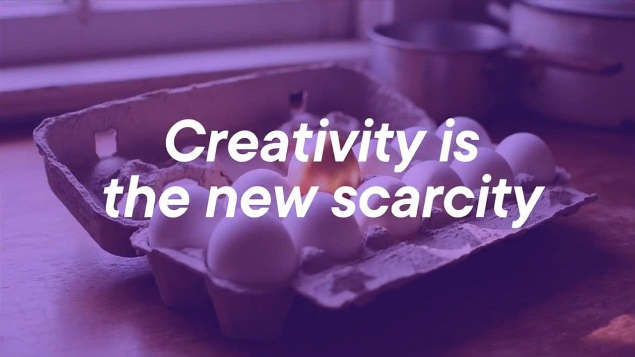 Egg carton with one egg on fire against a purple-tinted background, overlaid with the text Creativity is the new scarcity.