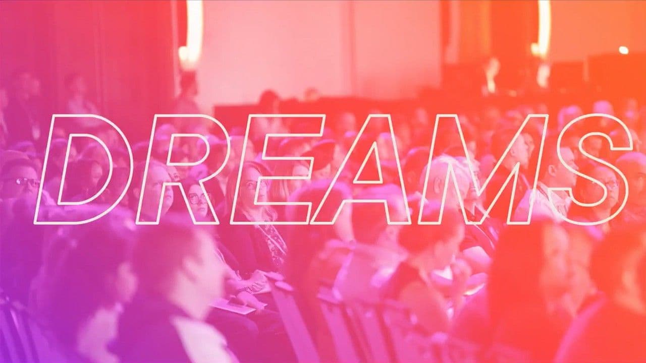 DPW New York conference audience viewed from the stage with the word DREAMS overlaid in large outlined letters against a warm gradient.